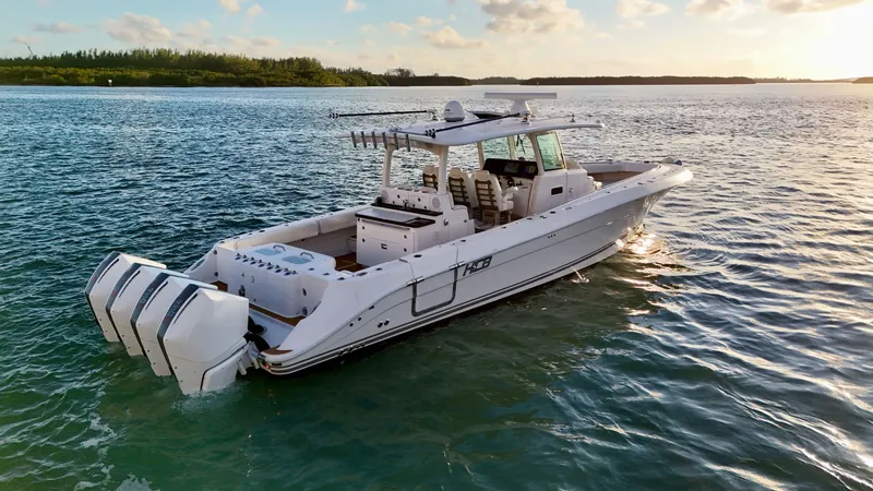 Slide: The Image of 2021 HCB Lujo boat on calm water at sunset. - 12