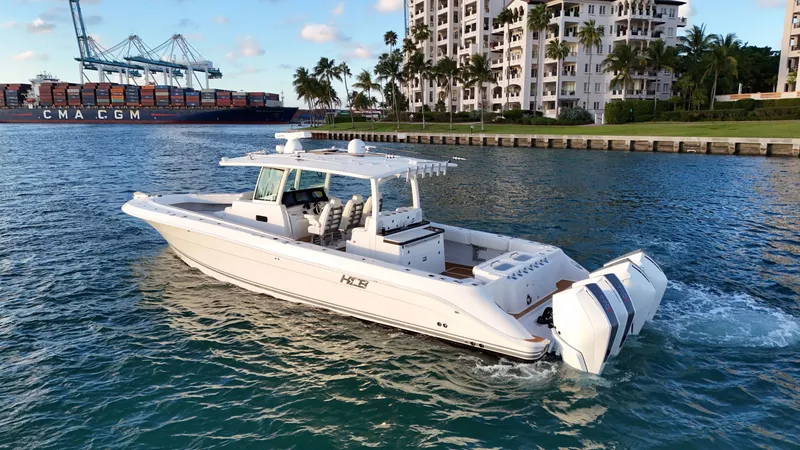 Slide: The Image of Luxury HCB Lujo 2021 yacht in harbor with cargo ship in background. - 5