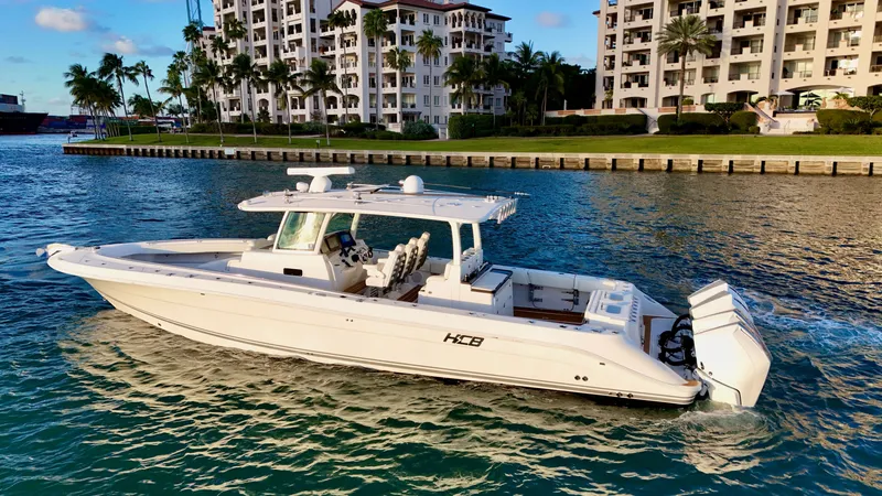 Slide: The Image of Luxurious 2021 HCB Lujo boat on calm water near modern buildings. - 6