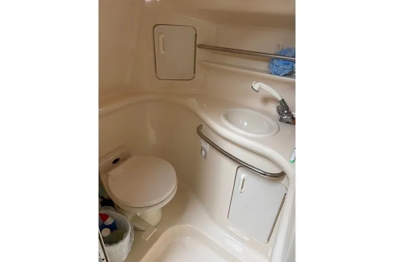 Slide: The Image of Bathroom interior of 1998 Sea Ray Sundancer 330 yacht, featuring sink and toilet. - 10