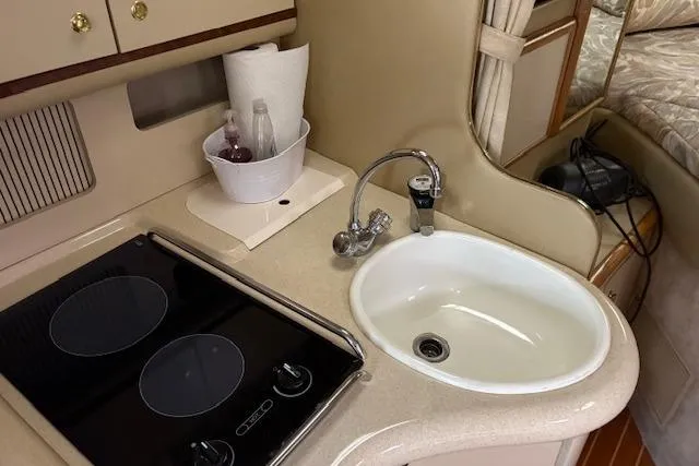 Slide: The Image of 1998 Sea Ray Sundancer 330 yacht kitchen with sink and stove. - 11
