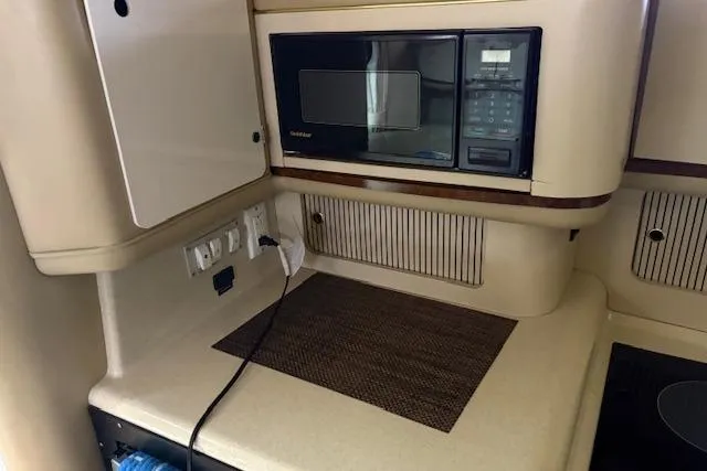 Slide: The Image of 1998 Sea Ray Sundancer 330 interior kitchen with microwave and countertop. - 12