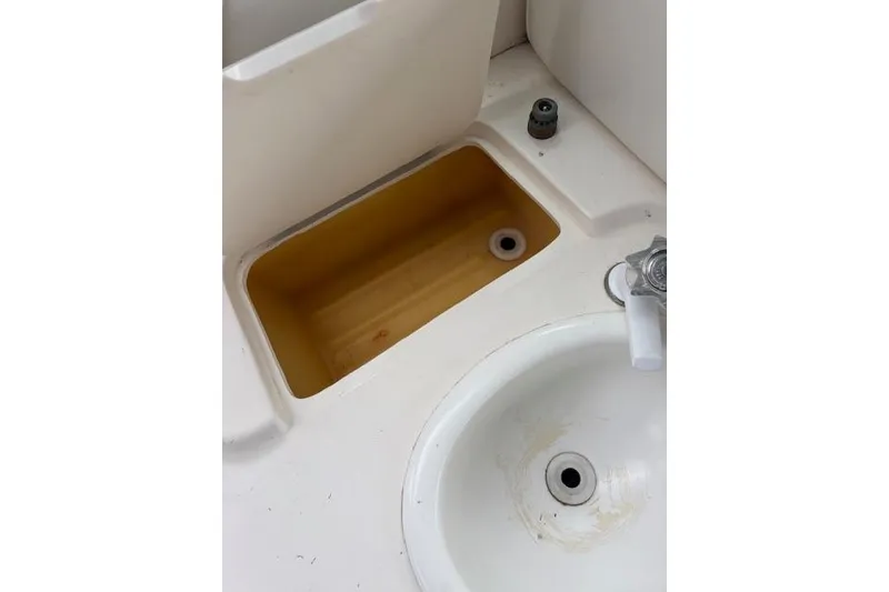 Slide: The Image of 1998 Sea Ray Sundancer 330 boat sink and storage compartment detail. - 15