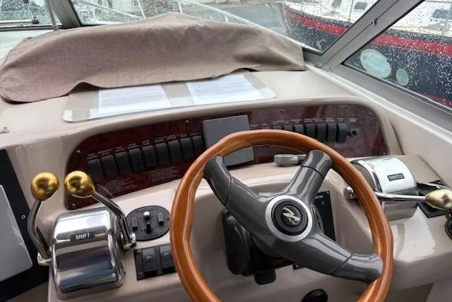 Slide: The Image of 1998 Sea Ray Sundancer 330 helm with wooden steering wheel and control panel. - 17