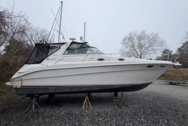 Slide: The Image of 1998 Sea Ray Sundancer 330 boat on stands, side view, outdoors. - 28