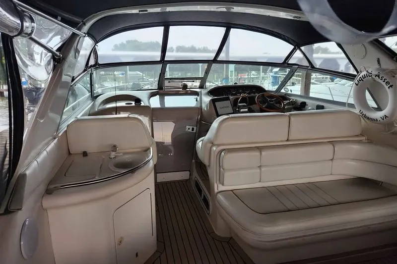 Slide: The Image of 1998 Sea Ray Sundancer 330 interior with helm, seating, and sink, featuring a panoramic view. - 31