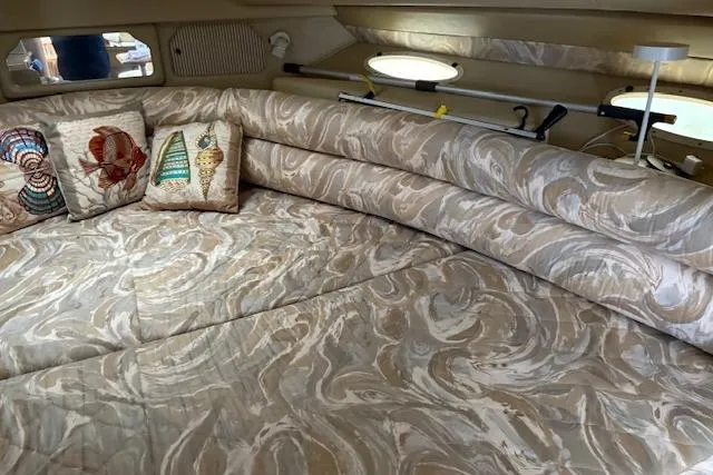 Slide: The Image of 1998 Sea Ray Sundancer 330 cabin interior with patterned upholstery and decorative pillows. - 7