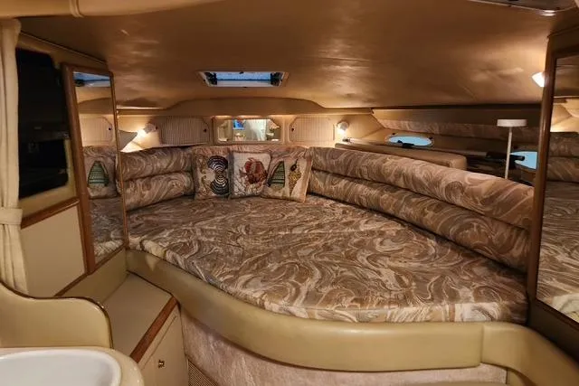 Slide: The Image of Interior of 1998 Sea Ray Sundancer 330 yacht with plush seating and decorative pillows. - 8