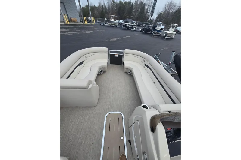 Slide: The Image of Interior of a 2018 Bennington 22SSX pontoon boat with beige seating. - 2