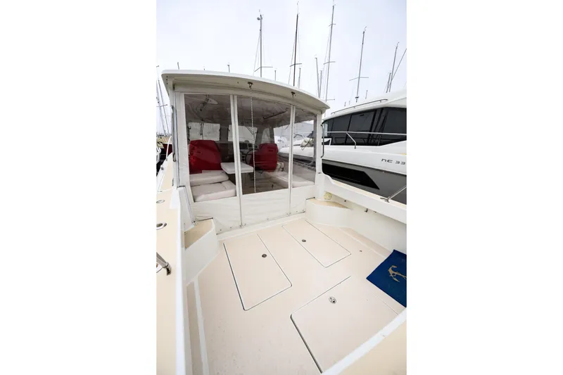 Slide: The Image of 2005 MJM 34z Downeast boat with enclosed cockpit and visible seating area. - 10