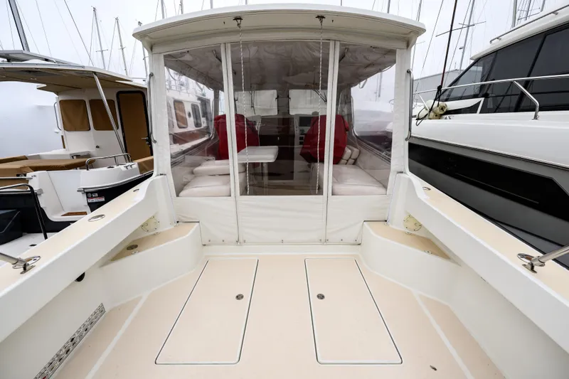 Slide: The Image of 2005 MJM 34z Downeast boat with enclosed seating area and visible deck. - 11