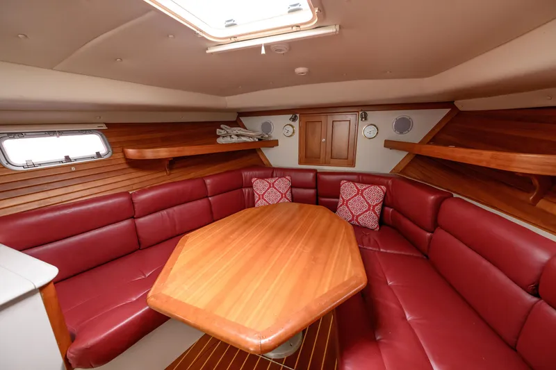 Slide: The Image of Luxurious 2005 MJM 34z Downeast yacht interior with red leather seating and wooden table. - 19