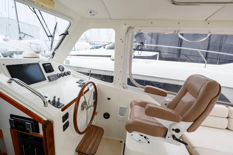 Slide: The Image of 2005 MJM 34z Downeast boat helm with leather captain's chair and navigation controls. - 23