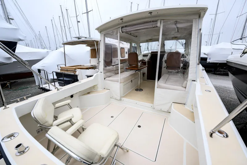 Slide: The Image of 2005 MJM 34z Downeast boat with spacious cockpit and covered seating area. - 26