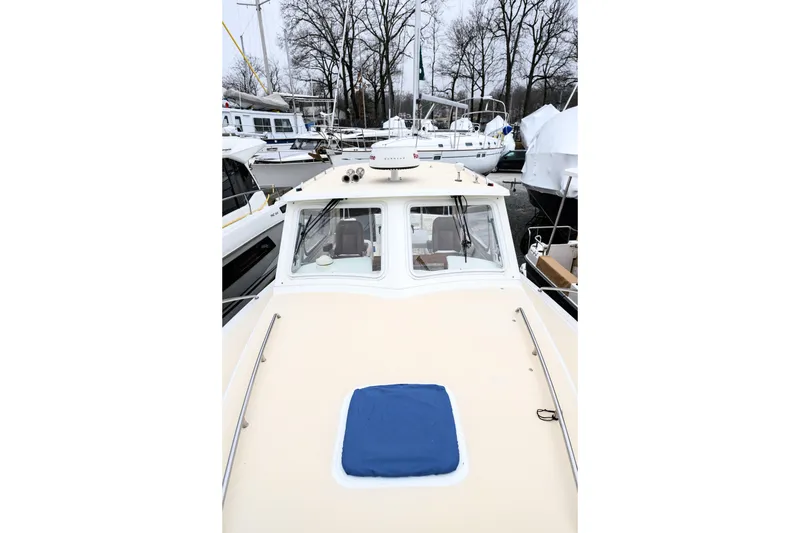 Slide: The Image of 2005 MJM 34z Downeast boat docked, showcasing its sleek design and spacious deck. - 4