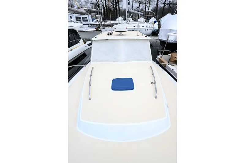 Slide: The Image of 2005 MJM 34z Downeast boat deck view, surrounded by other docked boats. - 6