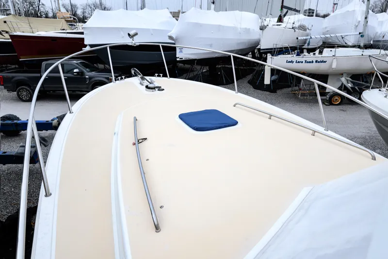 Slide: The Image of 2005 MJM 34z Downeast boat on land, surrounded by other covered boats. - 7