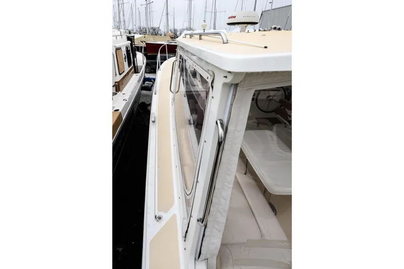 Slide: The Image of 2005 MJM 34z Downeast boat docked, showcasing sleek design and spacious interior. - 8