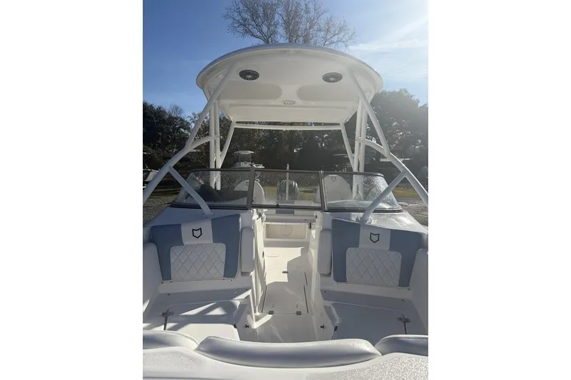 Slide: The Image of 2026 Sea Fox 228 Traveler boat interior with seating and canopy under clear sky. - 10