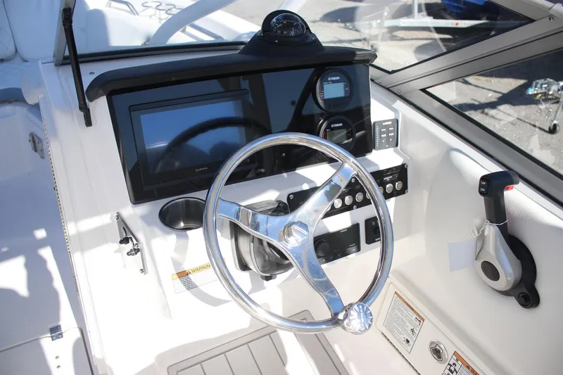 Slide: The Image of 2026 Sea Fox 228 Traveler boat dashboard with steering wheel and navigation controls. - 6