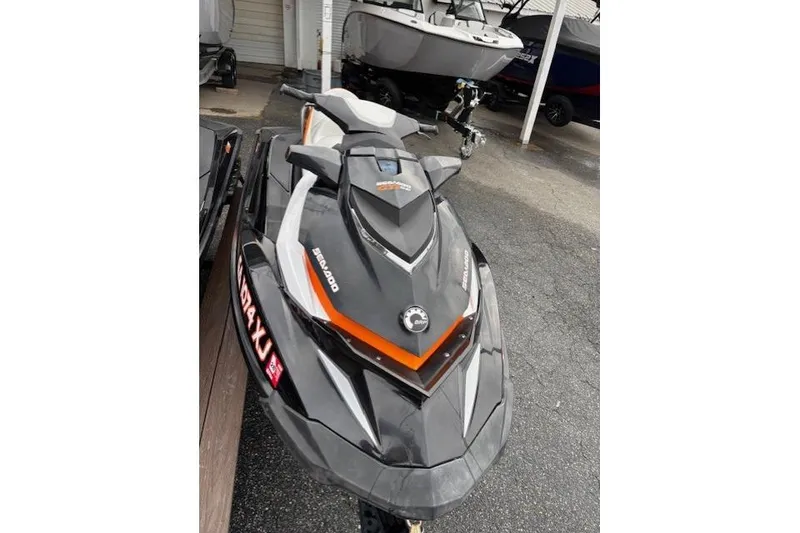 Slide: The Image of 2013 Sea-Doo GTI SE 130 jet ski in a showroom, featuring sleek design and vibrant colors. - 3