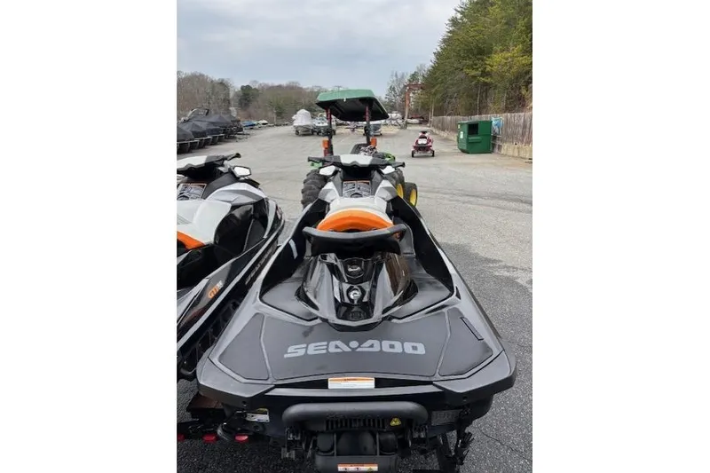 Slide: The Image of 2013 Sea-Doo GTI SE 130 jet ski parked outdoors on a paved surface. - 4