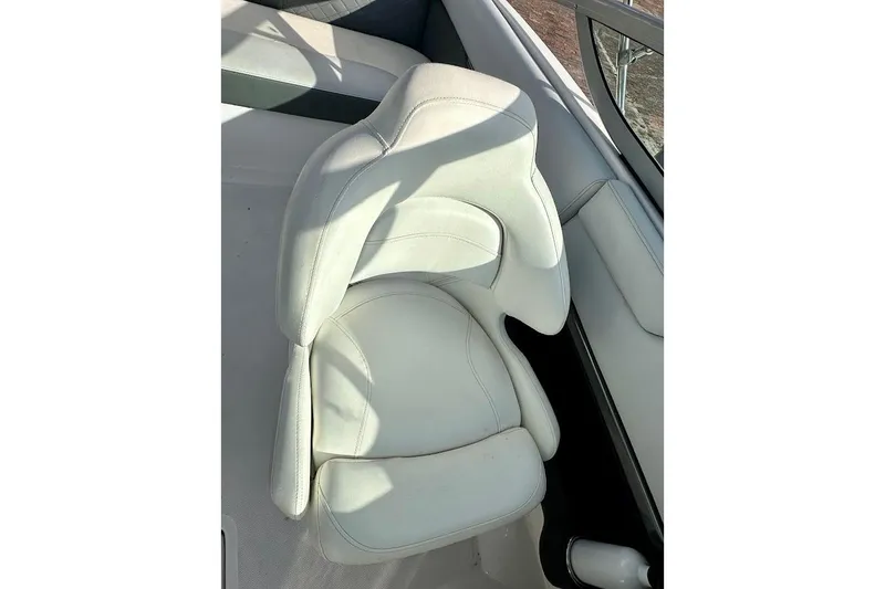 Slide: The Image of White seat on 2012 Regal 2100 Bowrider boat, featuring sleek design and comfortable cushioning. - 14