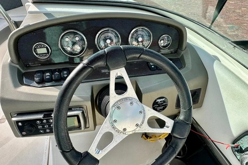 Slide: The Image of Steering wheel and dashboard of 2012 Regal 2100 Bowrider boat. - 16