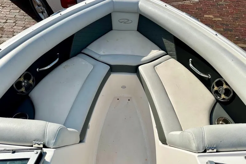 Slide: The Image of 2012 Regal 2100 Bowrider boat interior with cushioned seating and stainless steel accents. - 18