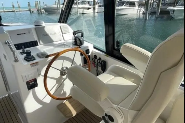 Slide: The Image of Interior of 2022 MJM 3 boat with steering wheel and control panel. - 2