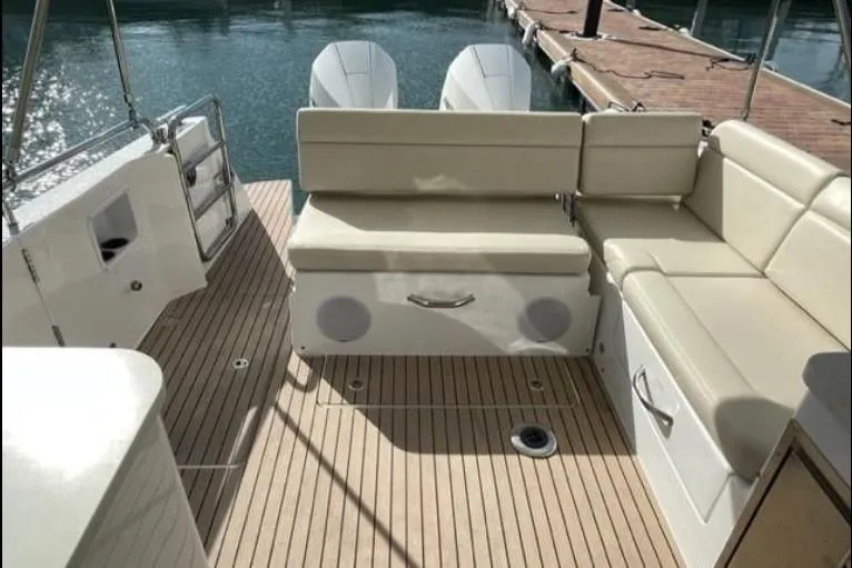 Slide: The Image of 2022 MJM 3 boat interior with beige seating and wooden deck. - 4