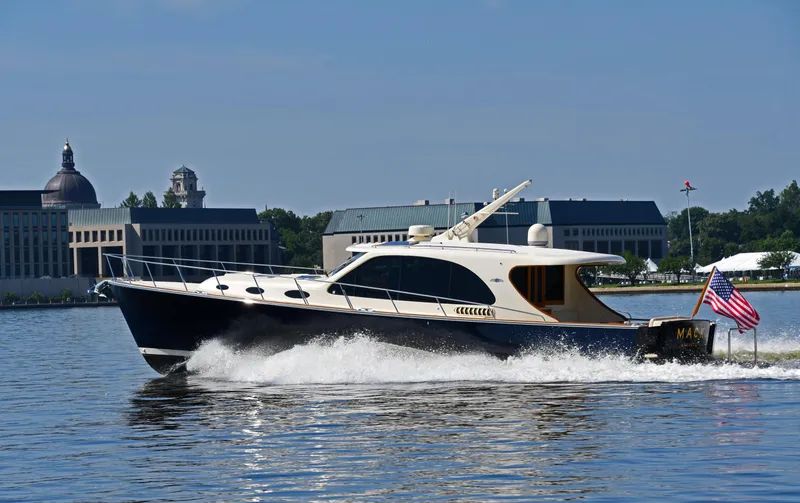 The Image of Palm Beach Motor Yachts PB52, 2020, cruising on water near buildings. - 0