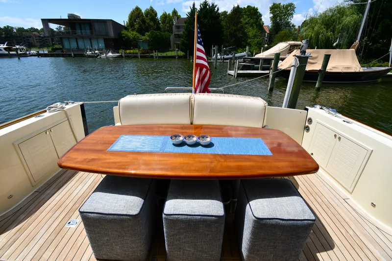 Slide: The Image of Luxury 2020 Palm Beach Motor Yachts PB52 deck with elegant dining setup. - 12