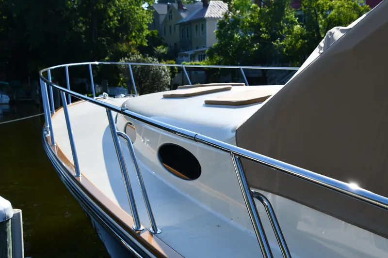 Slide: The Image of 2020 Palm Beach Motor Yachts PB52, sleek design, docked near lush greenery. - 15