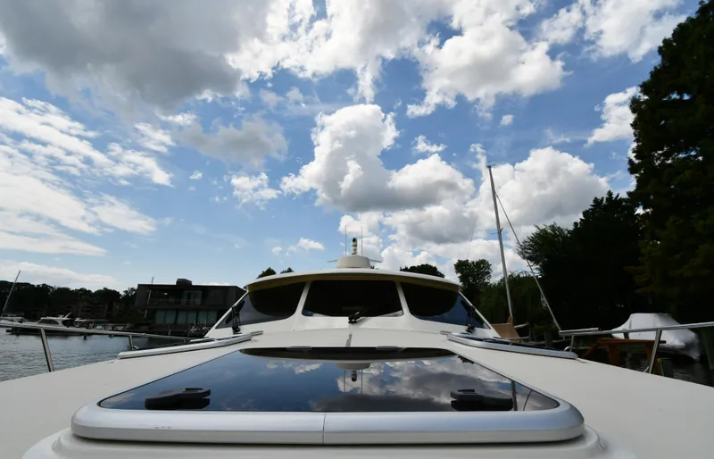 Slide: The Image of 2020 Palm Beach Motor Yachts PB52 on water under cloudy sky. - 16