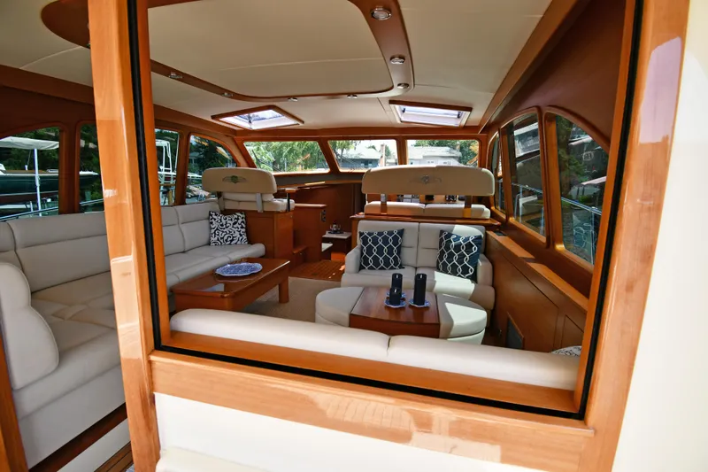 Slide: The Image of Luxurious interior of 2020 Palm Beach Motor Yachts PB52, featuring elegant seating and wooden finishes. - 19