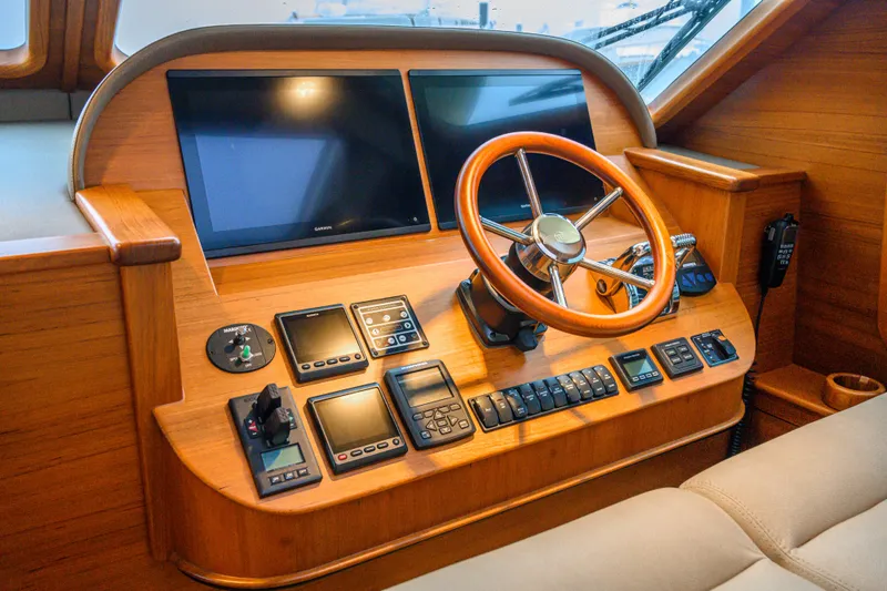 Slide: The Image of Helm of 2020 Palm Beach Motor Yachts PB52 with wooden steering wheel and modern controls. - 31