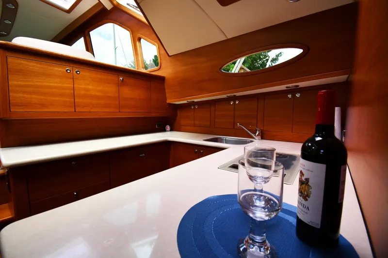 Slide: The Image of Luxurious 2020 Palm Beach Motor Yachts PB52 interior with elegant wood cabinetry and wine setup. - 38
