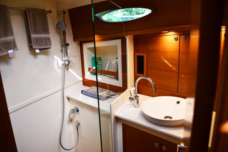 Slide: The Image of Luxurious bathroom interior of 2020 Palm Beach Motor Yachts PB52, featuring modern fixtures and wood accents. - 44