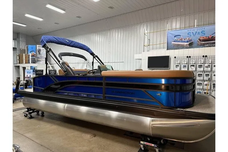 The Image of 2026 Bennington 22 SSB Swingback pontoon boat in showroom, blue and tan design. - 1