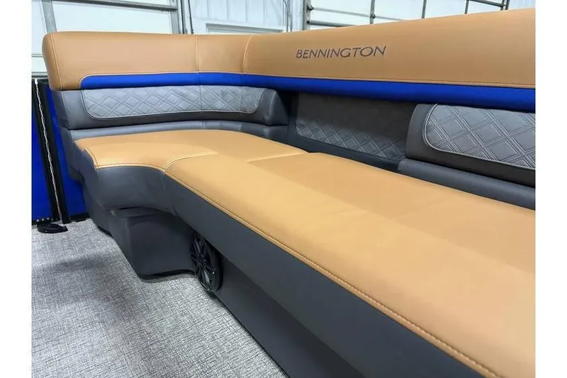 Slide: The Image of 2026 Bennington 22 SSB Swingback boat interior with tan and gray seating. - 11