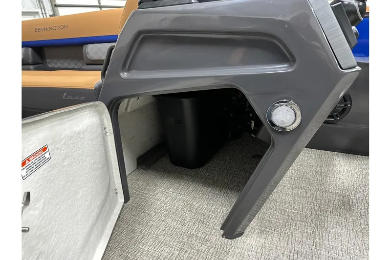 Slide: The Image of 2026 Bennington 22 SSB Swingback interior with storage compartment and seating. - 17