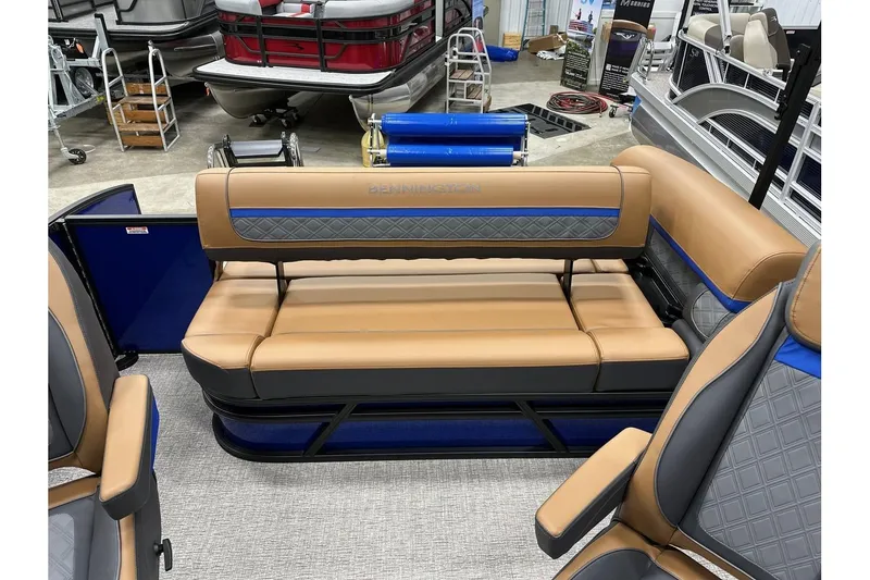 Slide: The Image of 2026 Bennington 22 SSB Swingback boat interior with tan and blue seating. - 25