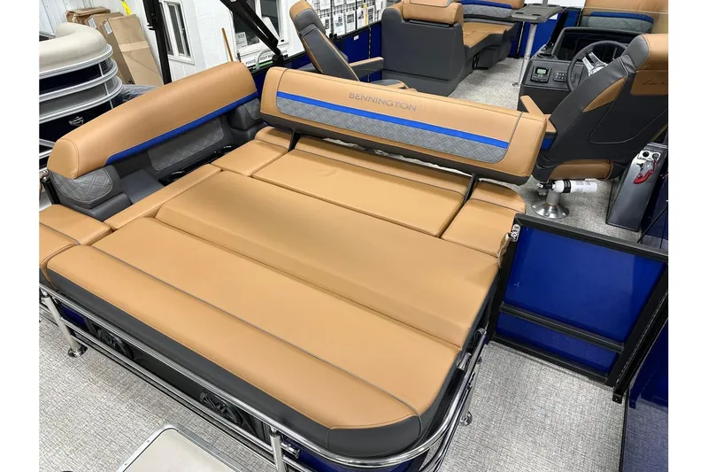 Slide: The Image of 2026 Bennington 22 SSB Swingback interior with tan seating and modern design. - 26