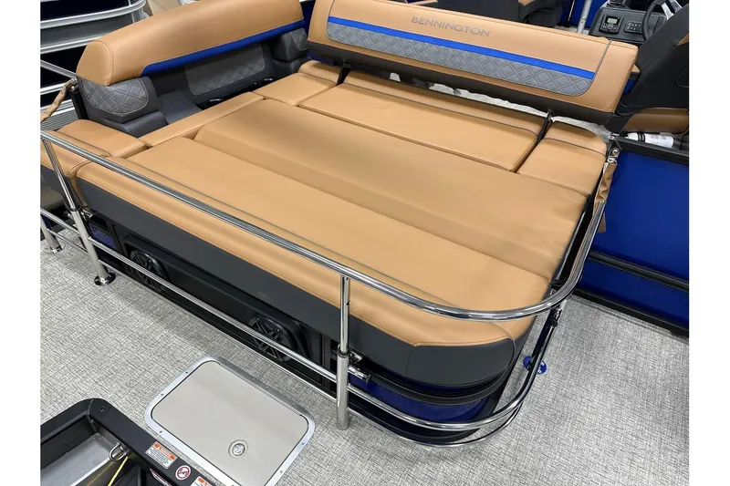 Slide: The Image of 2026 Bennington 22 SSB Swingback boat interior with tan seating and chrome railing. - 28