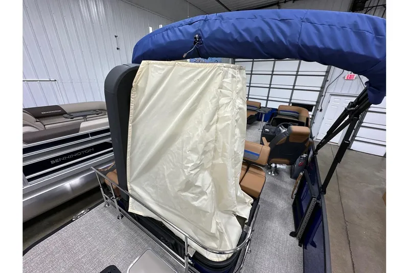 Slide: The Image of 2026 Bennington 22 SSB Swingback pontoon boat interior with blue canopy and beige seating. - 30