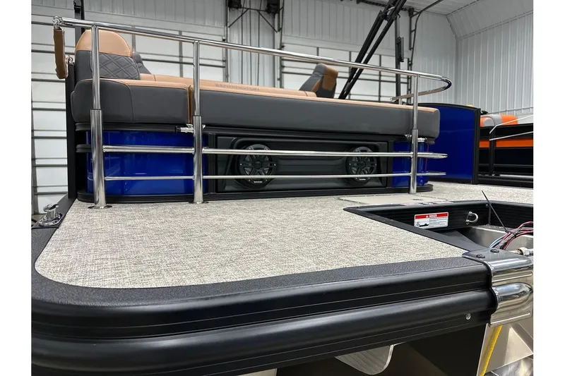 Slide: The Image of 2026 Bennington 22 SSB Swingback boat interior with seating and railing in a showroom. - 33