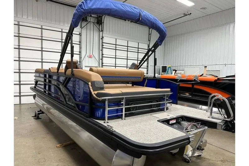 Slide: The Image of 2026 Bennington 22 SSB Swingback pontoon boat in stock, displayed in a showroom. - 4