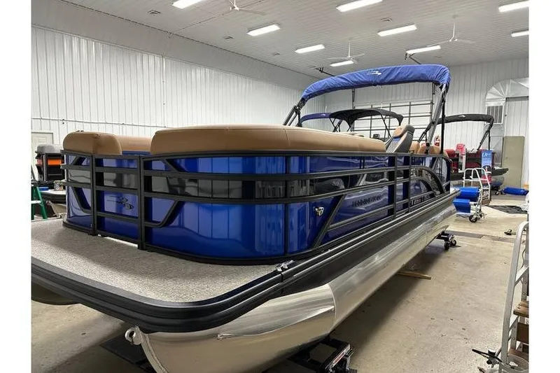 Slide: The Image of 2026 Bennington 22 SSB Swingback pontoon boat in stock, blue exterior, indoor showroom. - 6