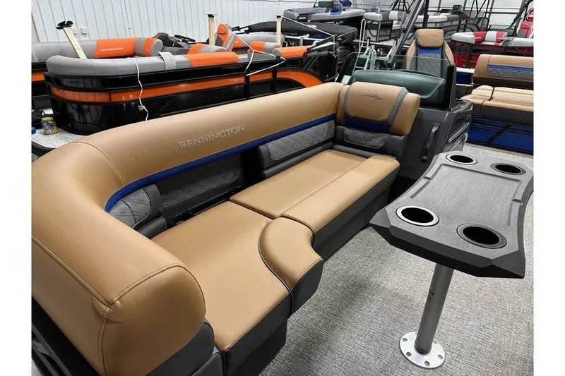 Slide: The Image of 2026 Bennington 22 SSB Swingback pontoon boat with tan seating and cupholder table. - 8